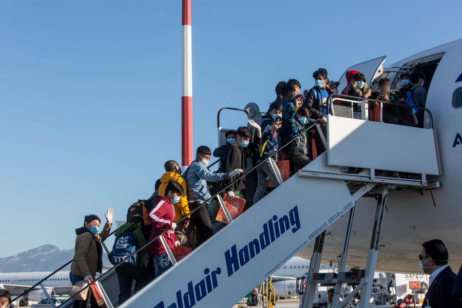 Group of people boarding a plane
